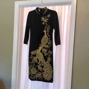 Asian style black stretch knit long sleeve dress with golden embroidery.